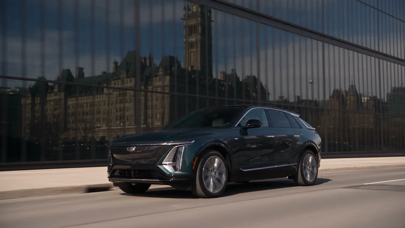 Black Cadillac driving past downtown Ottawa architecture